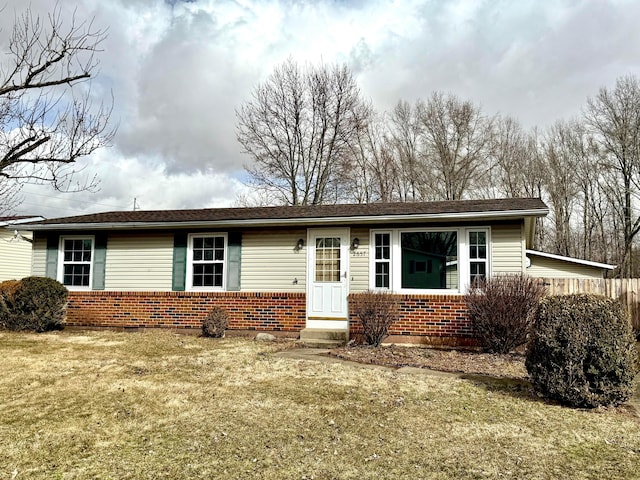 single story home with brick siding and a front lawn