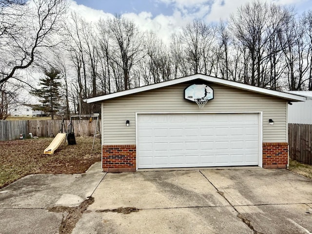 detached garage featuring fence