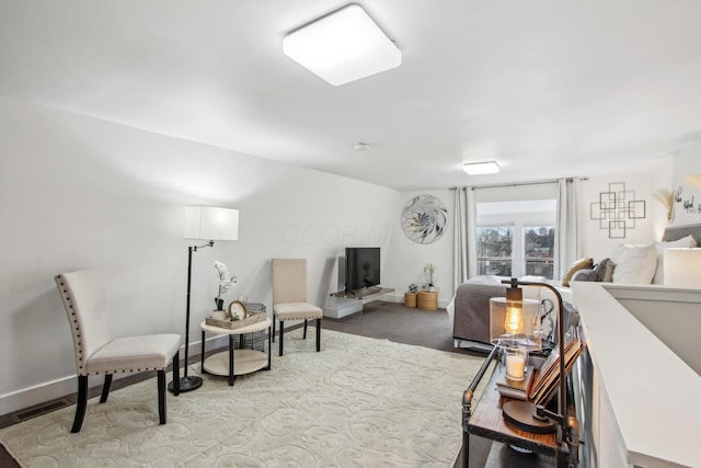 interior space with an upstairs landing, visible vents, and baseboards