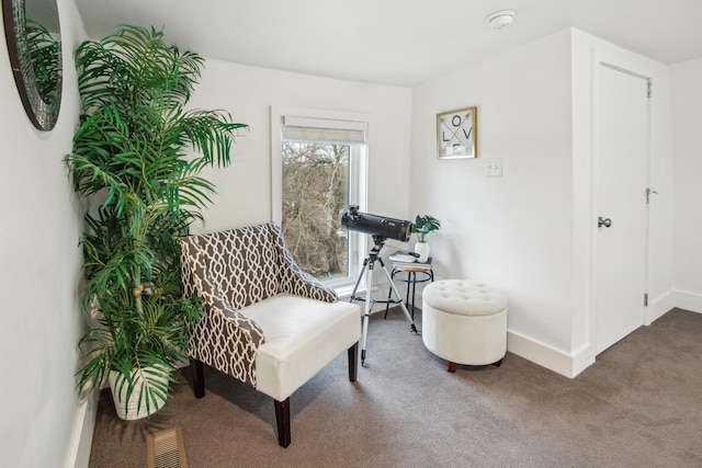 living area featuring carpet, visible vents, and baseboards