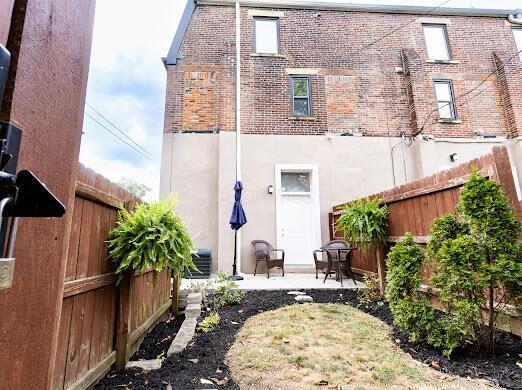 back of property with a patio area, a fenced backyard, and brick siding