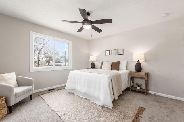 carpeted bedroom with baseboards, visible vents, and a ceiling fan