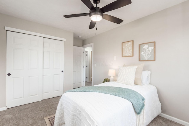 carpeted bedroom with ceiling fan, a closet, and baseboards