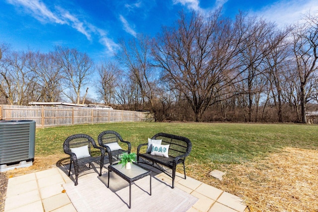 view of patio with central AC and fence