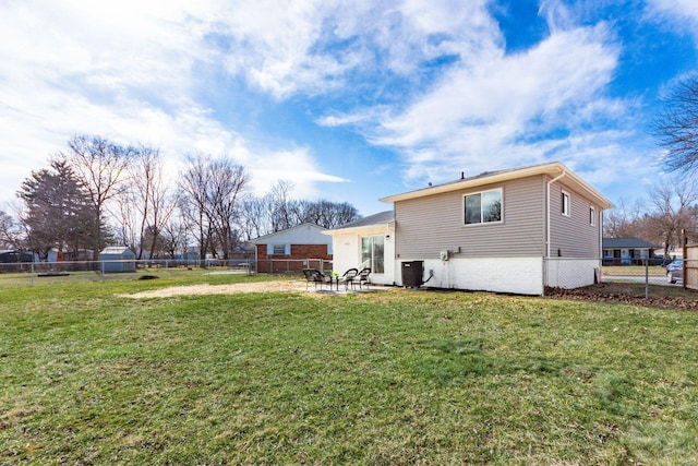 rear view of house with a yard, central AC unit, a patio, and a fenced backyard