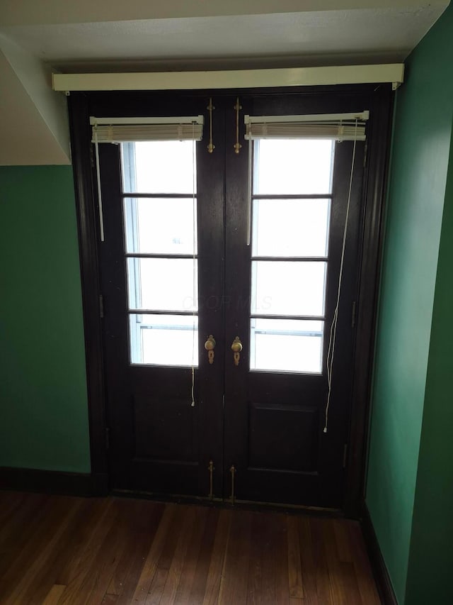 entryway with plenty of natural light, french doors, and dark wood finished floors