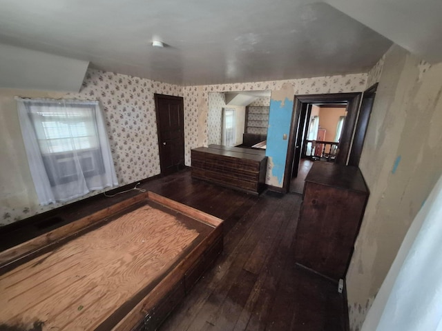 bedroom featuring hardwood / wood-style floors and wallpapered walls