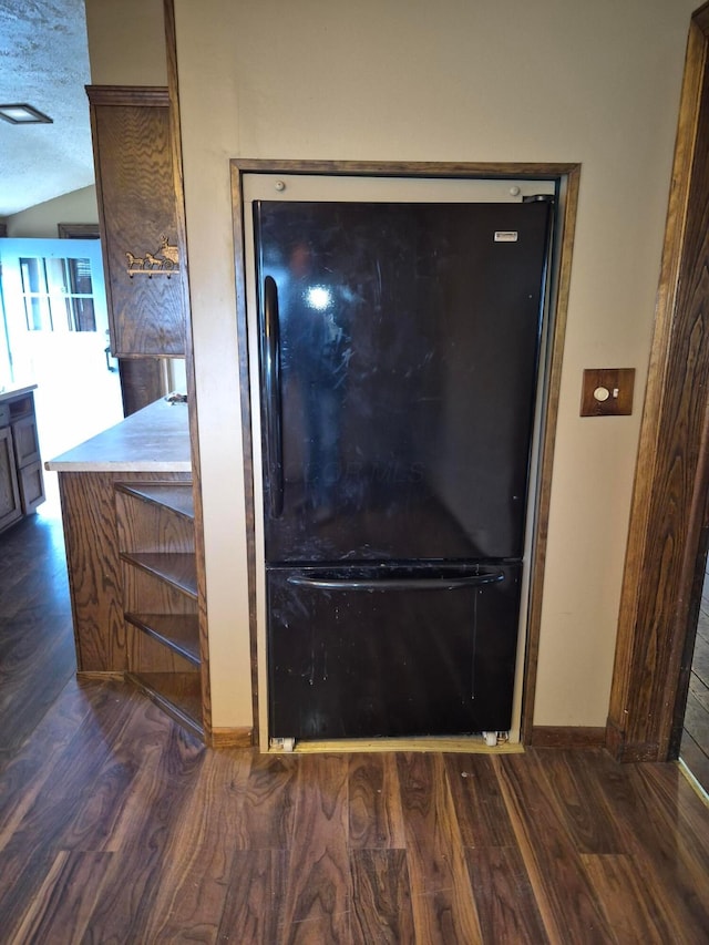 room details featuring freestanding refrigerator and wood finished floors