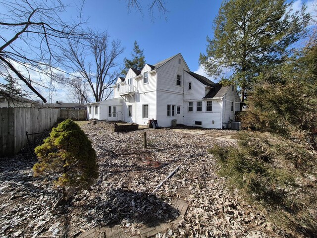 exterior space with a balcony, fence, and central AC