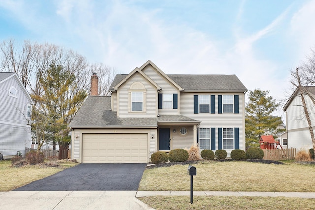 traditional home with aphalt driveway, roof with shingles, a chimney, a front yard, and fence