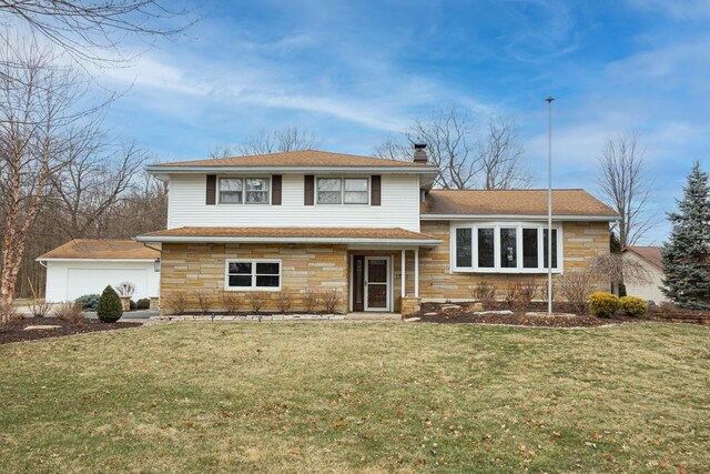 tri-level home featuring a chimney, a shingled roof, a front yard, stone siding, and an outdoor structure