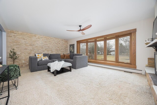 living area with carpet, a baseboard radiator, and a ceiling fan