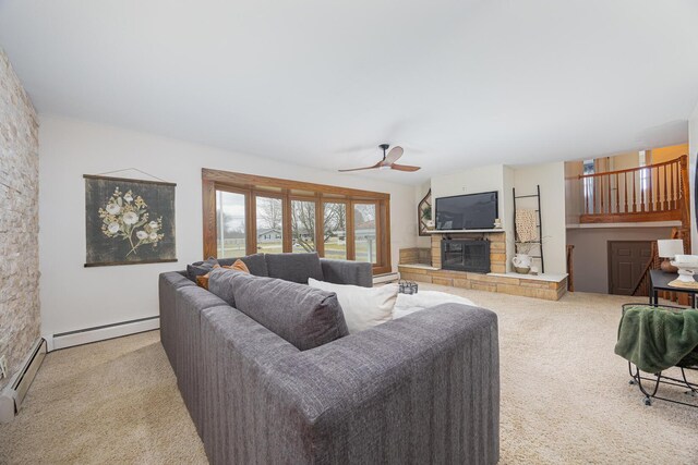 carpeted living room with a baseboard radiator, ceiling fan, and a stone fireplace