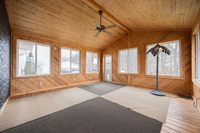 unfurnished sunroom with vaulted ceiling with beams, wooden ceiling, and a ceiling fan