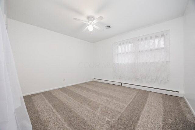 unfurnished room with carpet floors, visible vents, baseboard heating, a ceiling fan, and baseboards