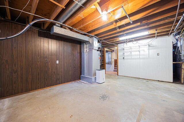 unfinished below grade area featuring wood walls