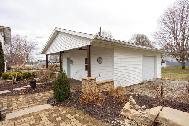 view of front of house with a garage, driveway, a porch, and a ceiling fan