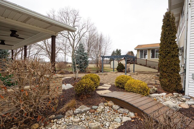 view of yard with a patio, a ceiling fan, and a pergola