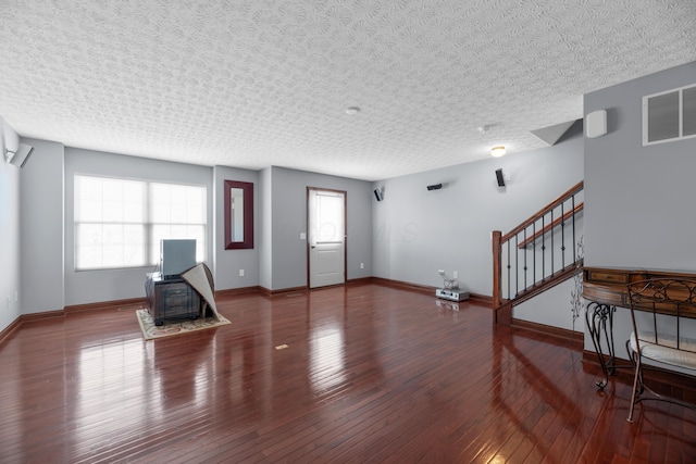 entryway with visible vents, stairway, baseboards, and hardwood / wood-style flooring