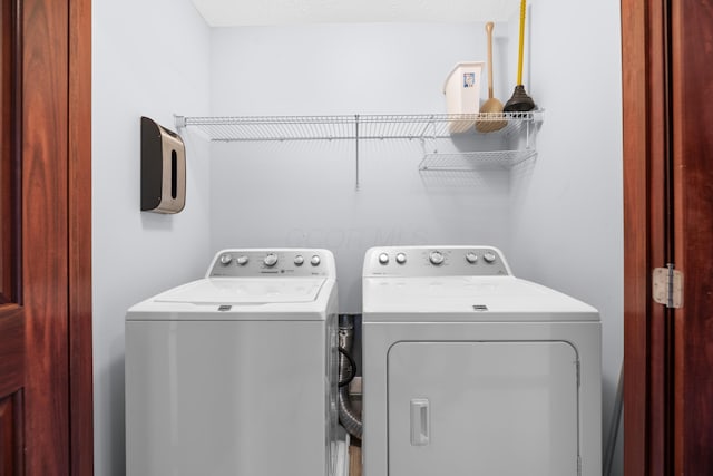 clothes washing area with separate washer and dryer
