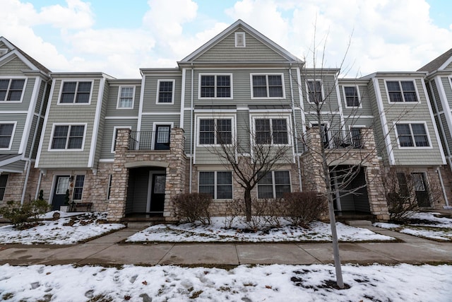 townhome / multi-family property featuring stone siding