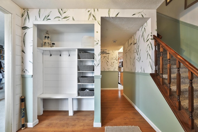 mudroom featuring baseboards and wood finished floors