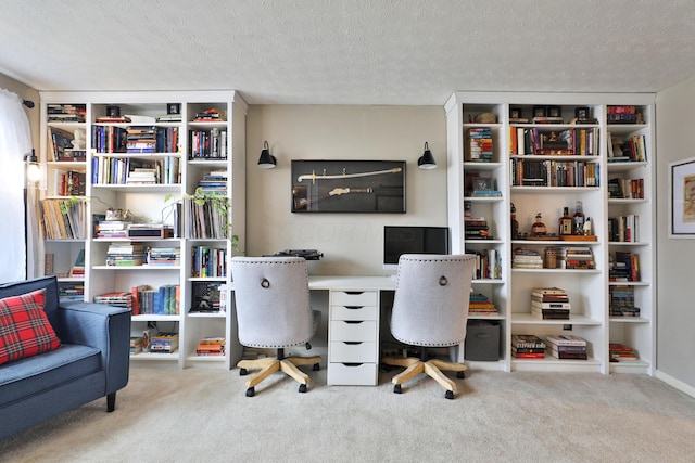 carpeted office featuring a textured ceiling