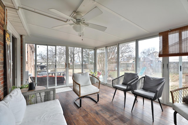 sunroom / solarium featuring a ceiling fan