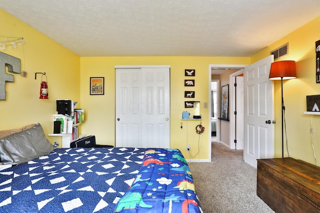 bedroom with carpet, a closet, visible vents, and a textured ceiling