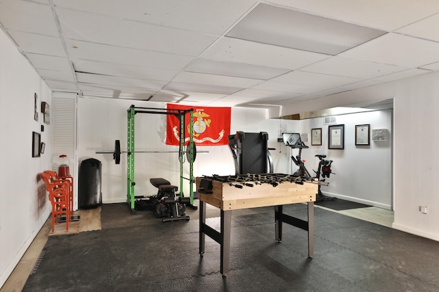 game room featuring baseboards, visible vents, and a drop ceiling