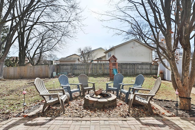 view of patio with a fenced backyard and a fire pit