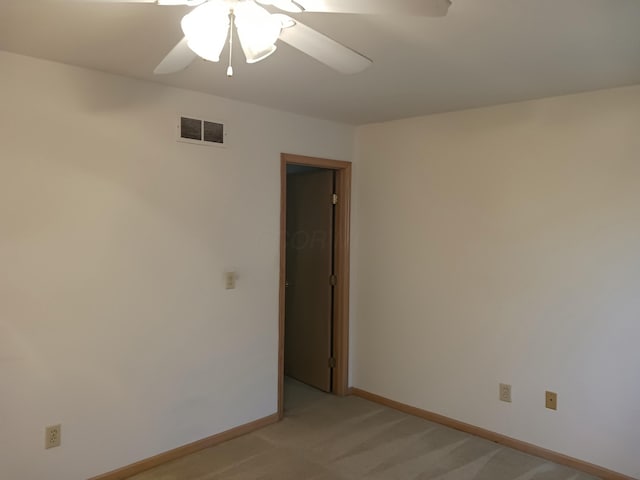 unfurnished room with ceiling fan, baseboards, visible vents, and light colored carpet