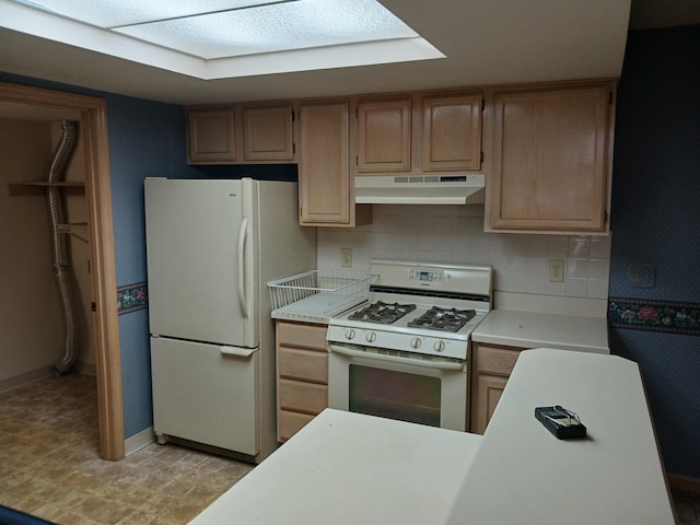 kitchen with under cabinet range hood, backsplash, white appliances, and light countertops