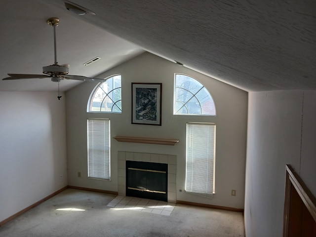 unfurnished living room with carpet floors, baseboards, visible vents, and a tiled fireplace