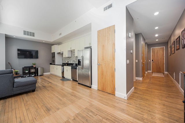 kitchen featuring stainless steel appliances, light wood-type flooring, visible vents, and white cabinetry