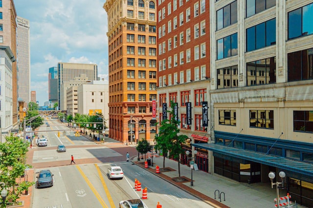 view of building exterior with a view of city and uncovered parking