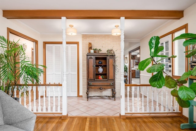 entryway with crown molding, beamed ceiling, and wood finished floors