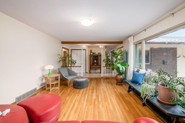 sitting room with visible vents and wood finished floors