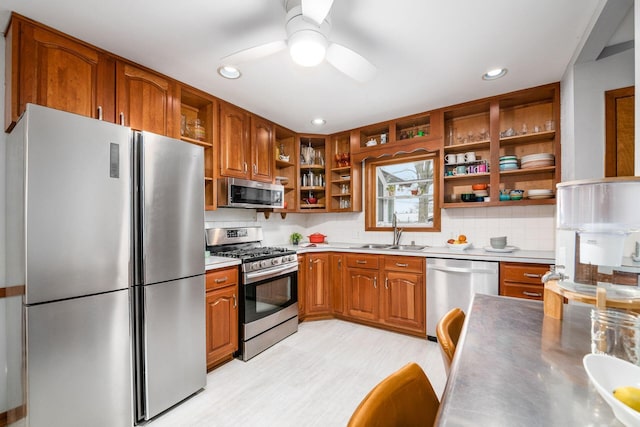 kitchen featuring a sink, open shelves, brown cabinets, and stainless steel appliances