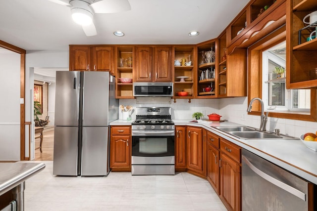 kitchen featuring open shelves, appliances with stainless steel finishes, light countertops, and a sink