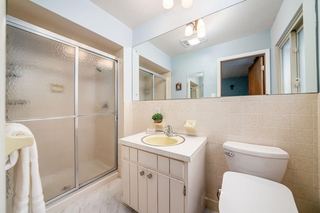 full bath with vanity, marble finish floor, a shower stall, and toilet