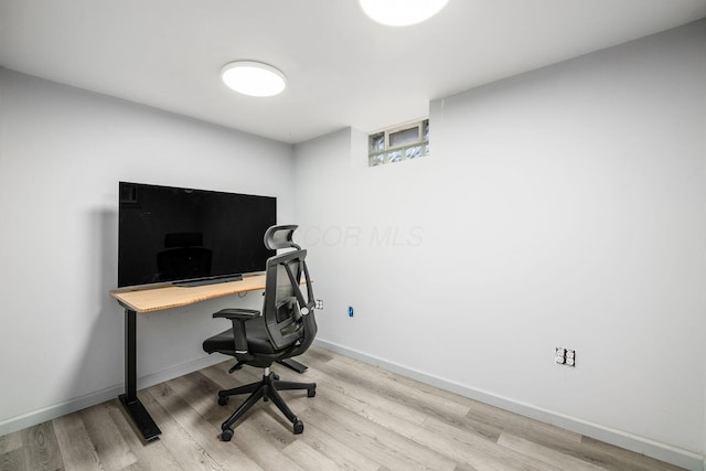 office space with baseboards and wood finished floors