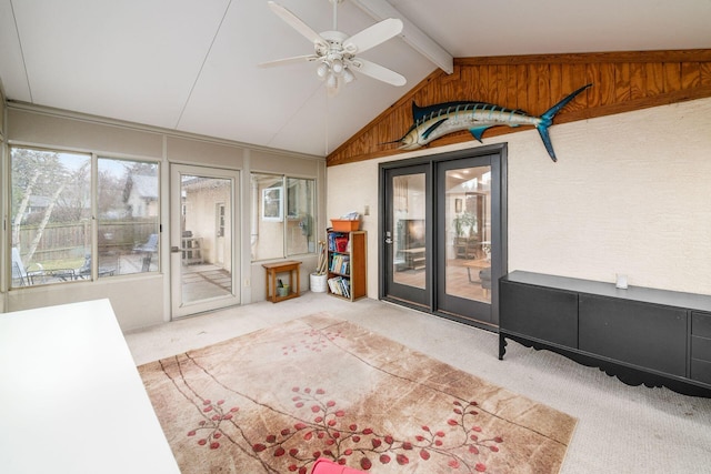 sunroom featuring vaulted ceiling with beams and ceiling fan