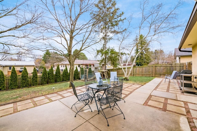 view of patio with outdoor dining space and a fenced backyard