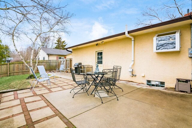 view of patio / terrace with grilling area, outdoor dining area, and fence