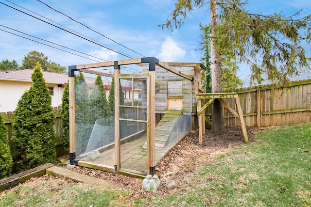 view of outbuilding with an outbuilding and fence