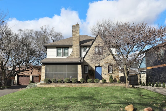 view of front facade featuring a shingled roof, a chimney, and a front lawn