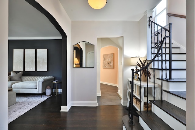 hallway with stairway, baseboards, and wood finished floors