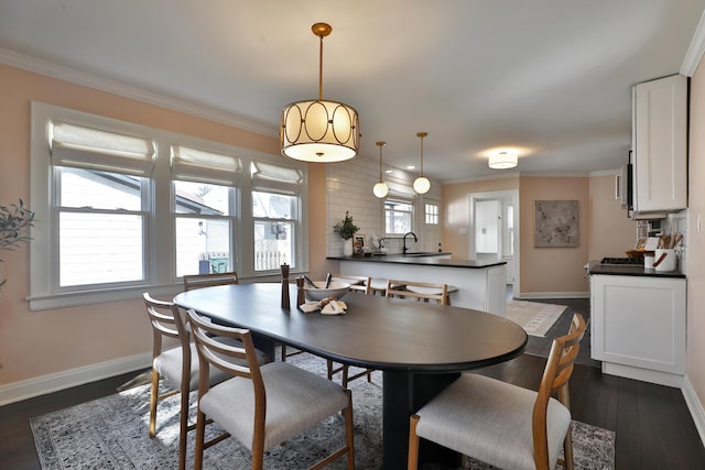 dining space with dark wood-style floors, baseboards, and crown molding