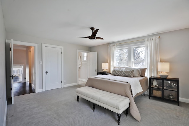 carpeted bedroom with ceiling fan, baseboards, and connected bathroom